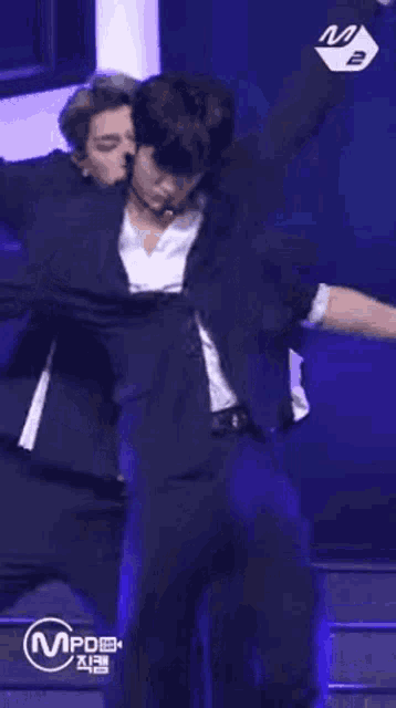 a man in a suit is standing on a stage .