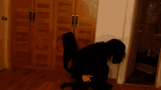 a person is sitting in a chair with their legs crossed