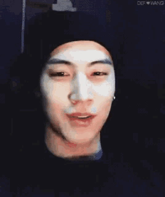 a close up of a person 's face with a white mask on .