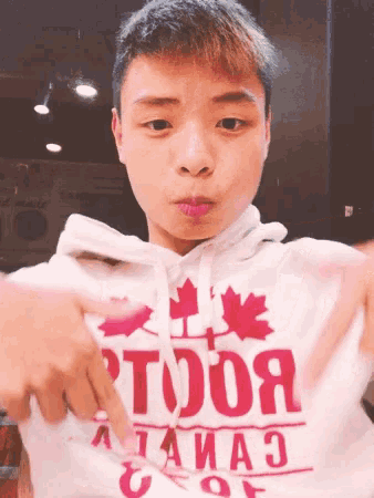 a young man wearing a hoodie that says toronto