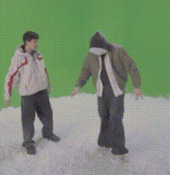a man in a hooded jacket stands in the snow