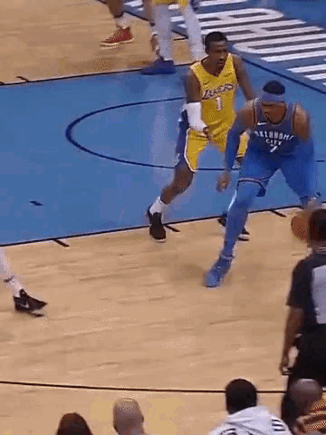 a basketball player wearing a lakers jersey is dribbling a ball