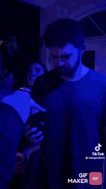 a blurry picture of a person wearing a headband in a dark room with blue lights .