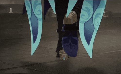 a person wearing a pair of blue shoes with a swirl design on the side
