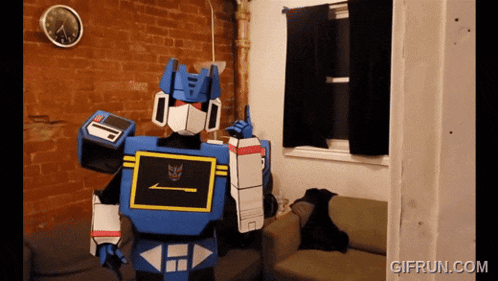 a gif from gifrun.com shows a person dressed in a robot costume
