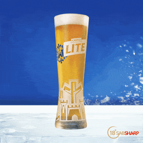 a glass of castle lite beer with a castle design on it