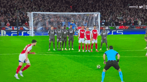 a group of soccer players standing in front of a goal with a sign that says ps5
