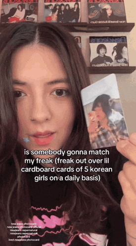 a girl holding a cardboard card that says " is somebody gonna match my freak " on it