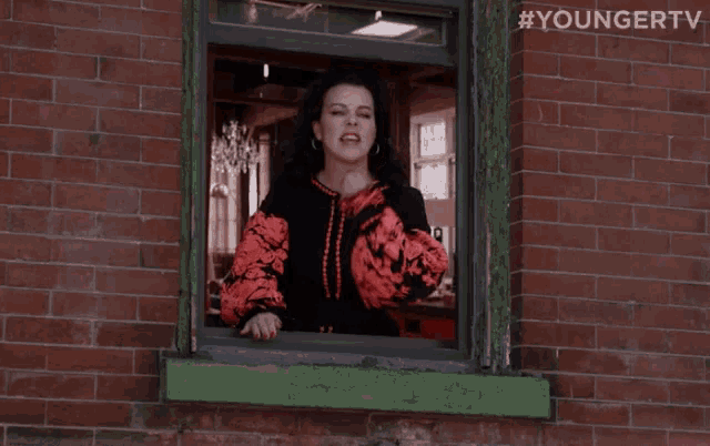 a woman is looking out of a window with the hashtag youngertv on the bottom