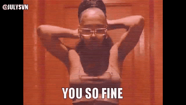 a woman wearing glasses is standing in front of a wall and says you so fine