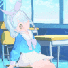 a girl is sitting at a desk in a classroom with a bunny ear headband .