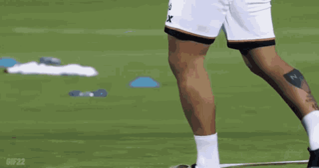 a soccer player wearing shorts that say x on them