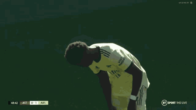 a soccer player with the number 7 on his jersey looks down