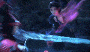 a man and a woman are fighting with a sword that is glowing blue and purple .
