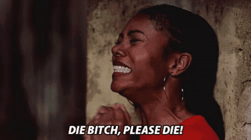 a woman in a red shirt is crying and saying die bitch please die !