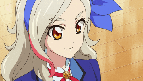 a girl with blonde hair and red highlights is wearing a blue bow around her head