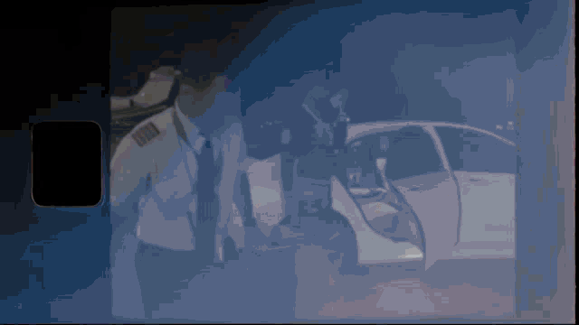 a man in a suit and tie is standing next to a white car
