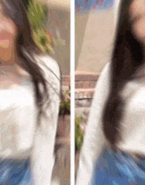 a blurry picture of a woman in a white top and blue shorts