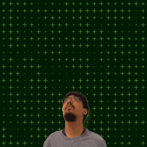 a man stands in front of a green background with the number 14 on it