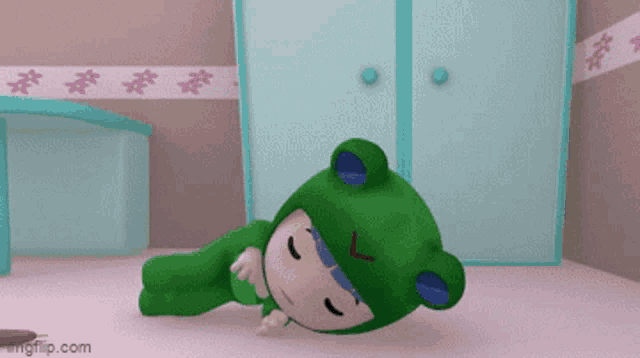 a cartoon character wearing a green frog costume is laying on the floor