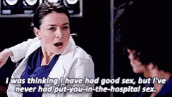 a woman in a lab coat is talking to a man in a hospital room .