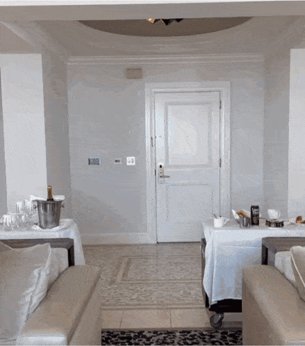 a hotel room with a bottle of champagne in a bucket on a table