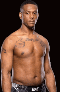 a man without a shirt has a tattoo on his chest that says forgiven