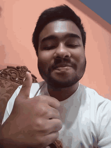 a man with a beard is smiling with his eyes closed