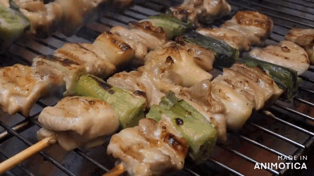 chicken skewers are being cooked on a grill and the words made in animatica are on the bottom