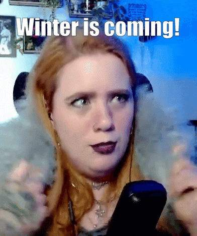 a woman holding a remote with the words winter is coming