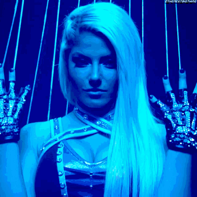 a woman with long blonde hair is wearing gloves with rhinestones
