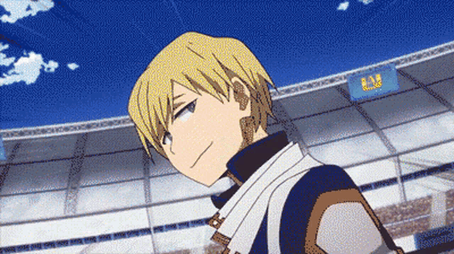 a man is standing in front of a stadium with a sign that says my hero academia .
