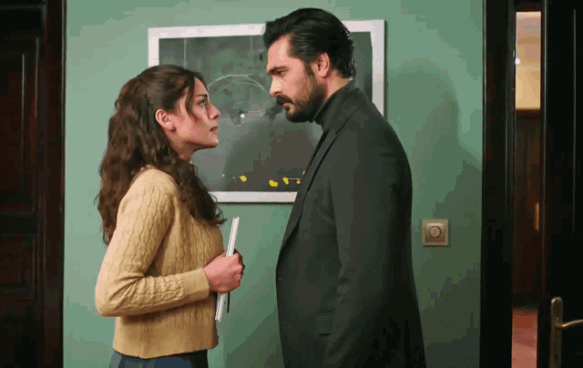 a man and a woman are standing next to each other