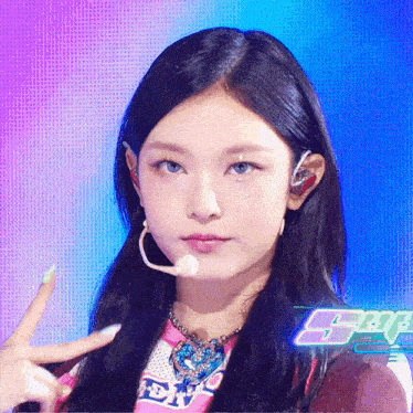 a girl wearing a microphone and a shirt that says sbs on it