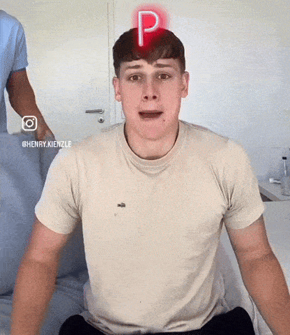 a young man with a red letter p on his head