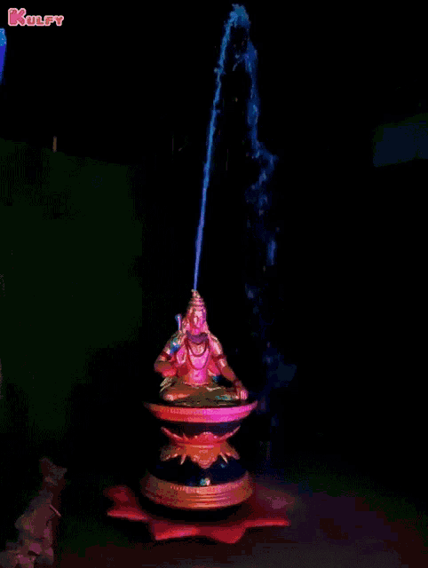 a picture of a statue of a deity with the word kolfy on the bottom right