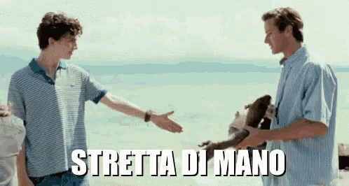 two men are shaking hands on a beach and the words stretta di mano are written above them