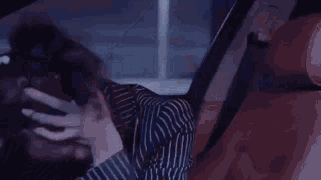 a close up of a person sitting in a car .