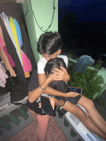 a boy and a girl are hugging each other