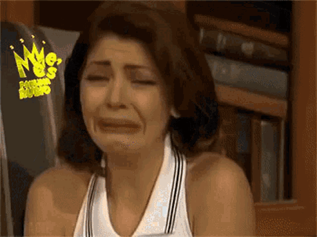 a woman is crying in front of a sign that says ' kings studio '