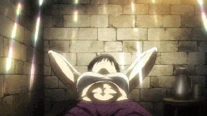 a woman is laying on a bed in front of a brick wall with her arms outstretched .