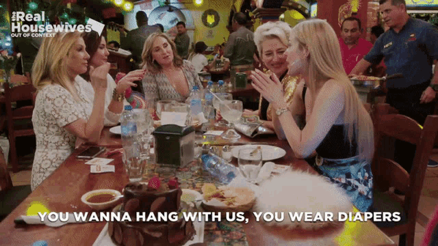 a group of women sitting at a table with the words you wanna hang with us you wear diapers above them