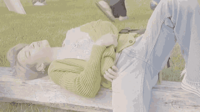 a close up of a person covering their face with their hand .