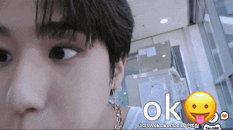 a close up of a person 's face with a smiley face and the word ok below it