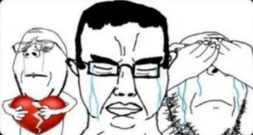 a man with glasses is crying while holding a broken heart in front of two other men .