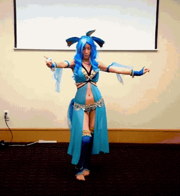 a woman with blue hair and a blue dress is standing in front of a projection screen