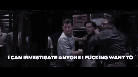 a man in a suit and tie is being attacked by a group of men in suits .