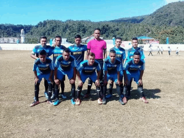 a group of soccer players are posing for a team photo on a field