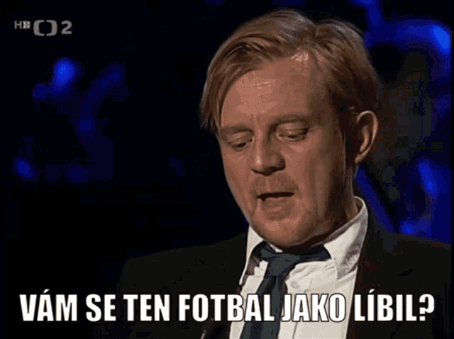 a man in a suit and tie says vam se ten fotbal jako libiil