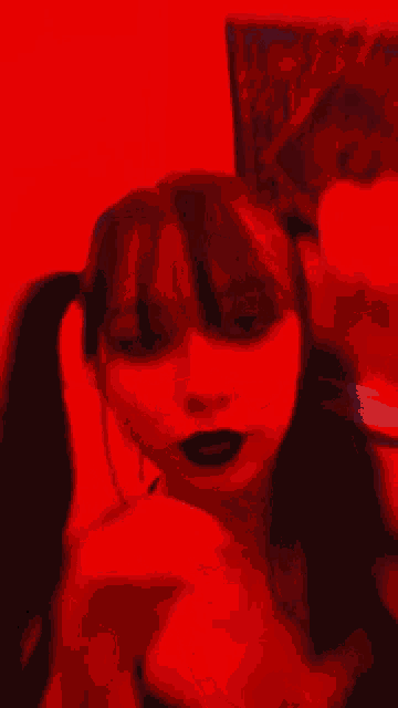 a blurry picture of a woman in a red light